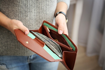 Wall Mural - Girl with brown wallet full of money