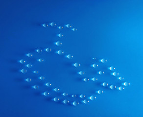 Whale made of water drops on blue background