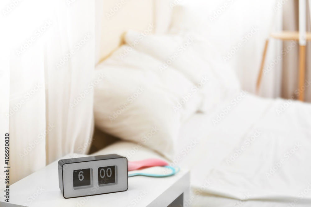 Empty bed with pillows and sheets in bedroom.