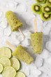 Homemade fruit popsicles on ice cube with kiwi and lime sliced.Top view.