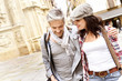 © goodluz - Tourists walking in historical quarter of spanish town