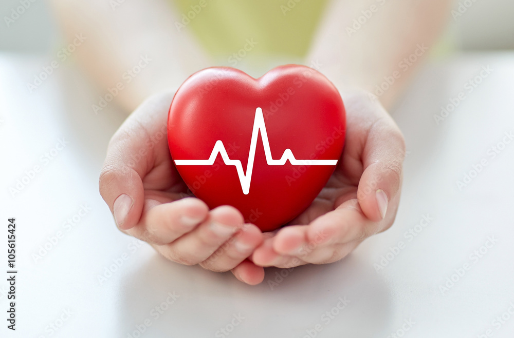 close up of hand with cardiogram on red heart - obrazy, fototapety, plakaty 