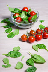 Wall Mural - healthy food concept - close up of salad with spinach and tomato