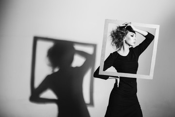  Сharismatic woman frame in his hands, fashion pose, black and white photo, studio shooting negativity, loneliness, divorce, pain, depression