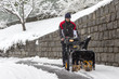 © caifas - man removing snow with a snow blower