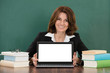 © Andrey Popov - Female Teacher With Laptop Sitting At Classroom Desk