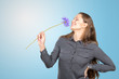 © fotofabrika - Attractive young woman holding a flower