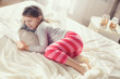 © GTeam - Cute little girl working with tablet computer lying in bed