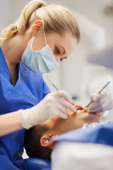 Sticker - female dentist checking up male patient teeth