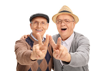 Canvas Print - Two senior gentlemen making peace sign