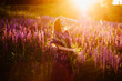 © Aleksei Zakharov - girl in field of purple wildflowers, sunset on Sunny day