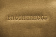 word brotherhood printed on metallic background