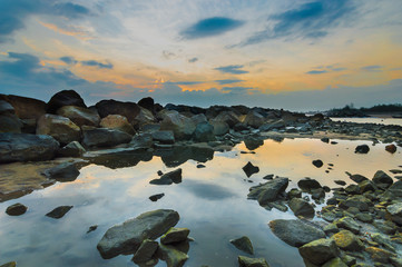 Wall Mural - Beach rock with sunrise background