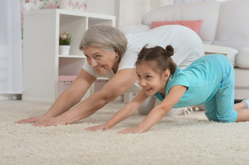 Canvas Print - little granddaughter doing exercise