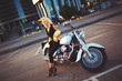 © Burdoff - young blonde woman sitting on a motorcycle on the background of