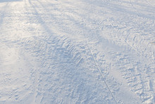 Road With Many Type Of Tire Tracks In The Snow