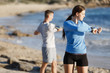 © Sergey Nivens - Young couple on beach training together