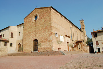 Wall Mural - large stone church with a sundial and a tower