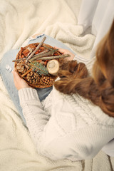 Wall Mural - Wicker basket with Christmas decoration in woman hands, closeup