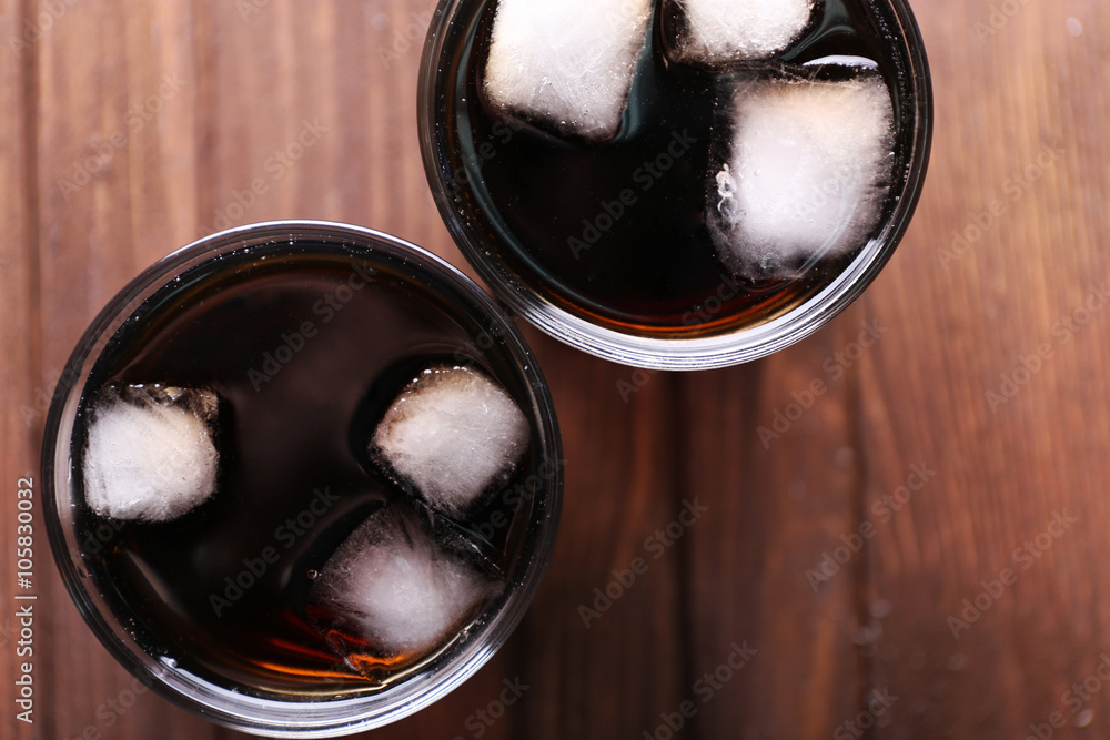 Cocktails with ice blocks  on wooden background, top view