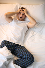 Wall Mural - Young man lying in bed at home