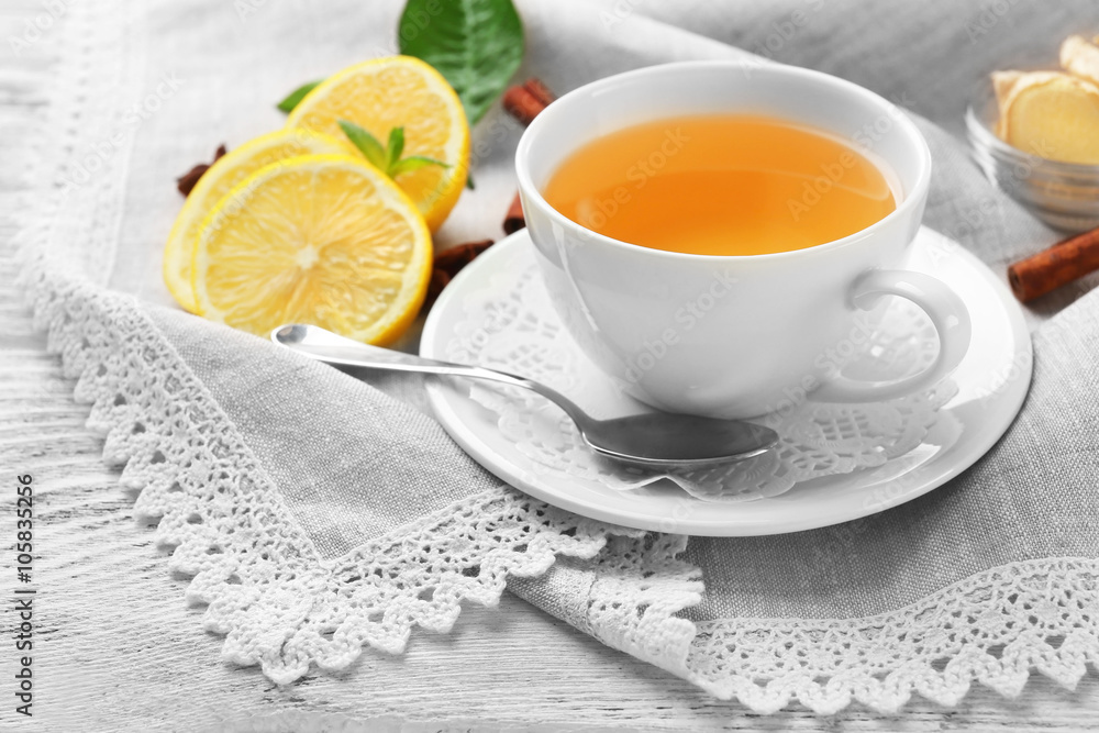 Cup of tea with ginger on napkin