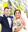 April Fools' Day. Wedding couple posing with crown, mask.