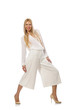 Blond hair model in elegant flared pants isolated on white