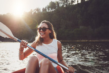 Smiling Young Woman Kayaking On A Lake