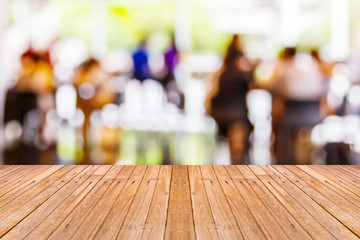 Old wooden table with blur coffee shop background