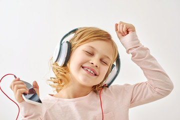 Happy girl dancing while listening to music 