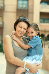 Wall Mural - mother with daughter near hotel