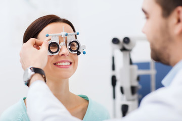 optician with trial frame and patient at clinic