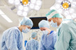 © Syda Productions - group of surgeons in operating room at hospital