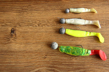 fishing lures on wooden background