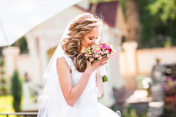 Beautiful bride outdoors in a park.