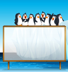 Wall Mural - Wooden frame with penguins on ice