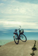 Bicycle at the beach on cloudy sky background. vintage retro sty