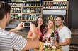 © WavebreakmediaMicro - Man taking picture of friends