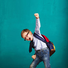 Smiling Little Boy With Big Backpack Jumping And Having Fun