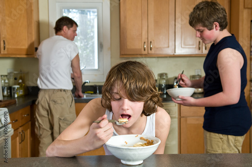 Fotografie, Obraz Family breakfast fun - candid shots of teen brothers having cereal, focus on you