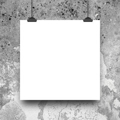 Close-up of one hanged square blank frame with clips against rough wall background