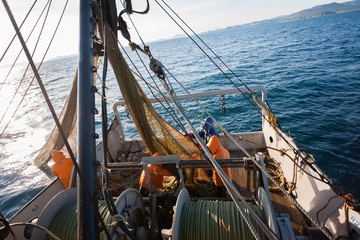 Fishermen pull trawl fish