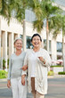 © DragonImages - Happy senior female friends walking in the city