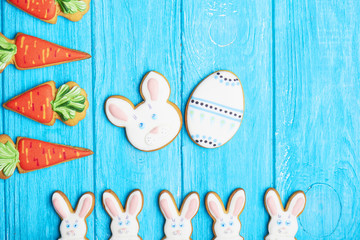 Colorful easter rabbit cookies on blue wooden background