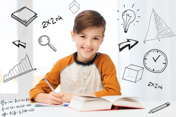 Wall Mural - smiling student boy writing to notebook at home