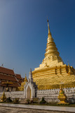 Fototapeta Most - Golden Pagoda with Blue Sky, Wat Phra That Chae Hang - Nan, Thai