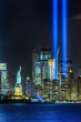 NEW YORK CITY - SEPTEMBER 11: The Statue of Liberty as seen in the evening of September 11, 2015 in New York City.  The 9-11 memorial lights can be seen in the background.