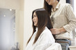 © Monet - Long hair of the woman is trying to cut the hair at the beauty salon