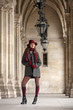 © ginkgofoto - Beautiful young woman with hat and stockings standing in arcades
